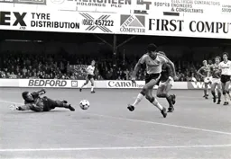 Mick Harford has the keeper beaten for his hat trick goal