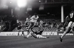 Brian Stein rides the lunging tackle of former Hatter Paul Elliott