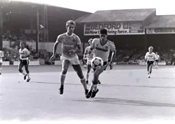 The ball gets away from Mike Newell and Mick McCarthy