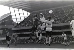 Ricky Hill leaps ahead of Richard Gough and heads the ball on