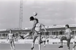 Ricky Hill and Mike Phelan challenge for the ball