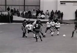 The ball goes loose in the Rangers penalty area. Peter Nicholas and Richard Harvey are the nearest Hatters to the ball