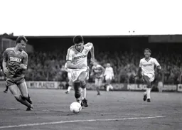 Mike Newell brings the ball into the penalty area with Mark Stein in close support