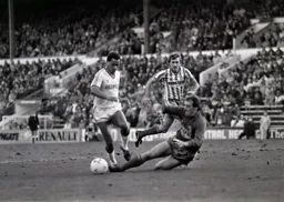 Brian Stein attempts to take the ball around Martin Hodge