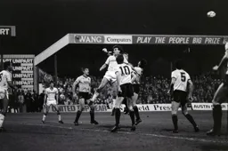 United keeper Mike Hardwick punches the ball away from the head of Mal Donaghy