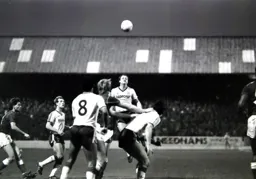 Peter Nicholas heads the ball forward