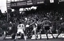 Les Sealey gets a hand to the ball to clear the danger