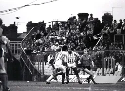 The Town clear their lines as Tim Breacker and Cyrille Regis watch the flight of the ball