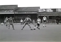 Mike Newell squeezes the ball between defenders