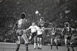 Gary Gillespie gets above and Mike Newell to head the ball clear