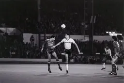 Mark Lawrenson heads the ball away from Mike Newell