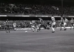 Mike Newell shoots before Terry Fenwick can get a block in