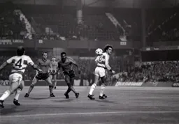 Ricky Hill shoots as Mike Fillery turns his back on it