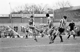 Mick Harford takes a shot at goal as Glenn Roeder flintches
