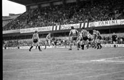 Peter Nicholas shoots into a crowd of players