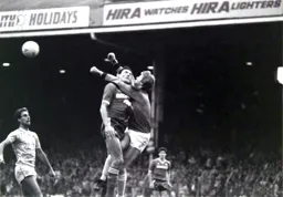 Mick Harford and Perry Suckling collide as they bravely go in for the ball