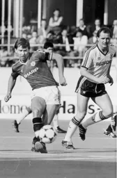 Peter Nicholas watches on as Bryan Robson plays the ball forward