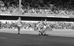 Gavin Maguire gets his foot to the ball to stop Mark Stein