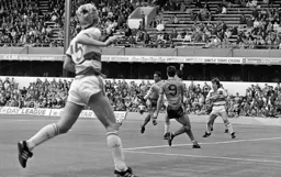 Gavin Maguire just does enough to take the ball away from Brian Stein