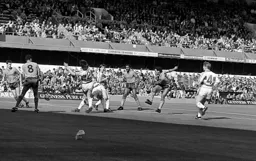 Mark Stein shoots through a crowded penalty area
