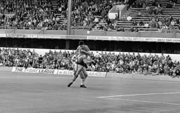 Mike Newell holds off a defender to get a shot on goal