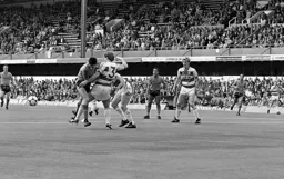 Robbie James knocks the ball away from Mike Newell