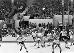 Mike Newell and Mick Harford watch as Trevor Peake heads the ball clear