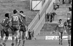 Ricky Hill and Mike Newell congratulate Mick Harford after scoring a late winner