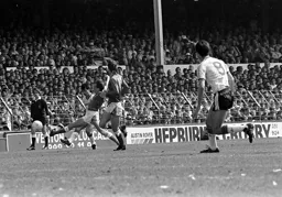 Rob Johnson gets forward and tries a shot at goal