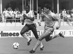 Raphael Meade in a race for the ball with Brian Borrows