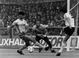 Mick Harford shoots but the attempt is blocked