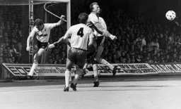 Danny Wilson flies in as Bryan Gunn punches the ball clear