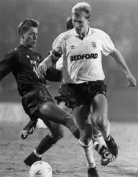 Tim Breacker rides a tackle