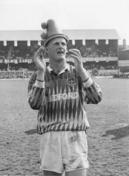 Iain Dowie celebrates by wearing a silly hat
