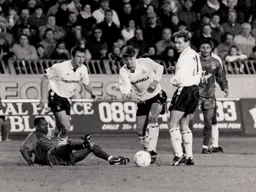Steve Williams dribbles past a floored Ian Wright