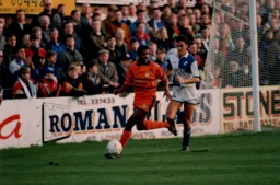 Ian Benjamin looks to play the ball back