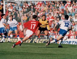 Ceri Hughes moves to clear the ball from danger