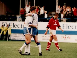 Scott Oakes is embraced by Ceri Hughes after scoring Town`s fifth goal