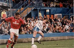 John Hartson watches as Charlie Bishop clears the ball