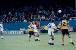 Alan Harper looks to find Paul Dickov with a clearance