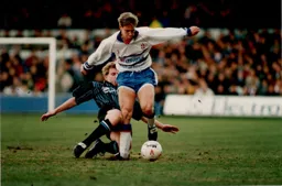 Julian James avoids a sliding tackle