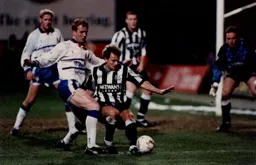John Hartson brings the Newcastle defence under pressure