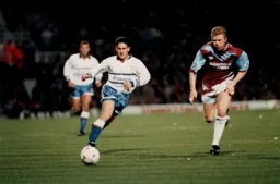 Paul Telfer in a chase for the ball with David Burrows