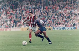 Dwight Marshall about to be wrestled to the floor by John Dreyer