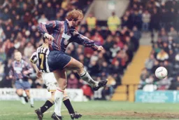 John Hartson gets a shot away