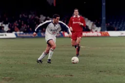 Jan Aage Fjortoft watches on as Paul Telfer advances with the ball