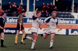 Gary Waddock moves over to congratulate James