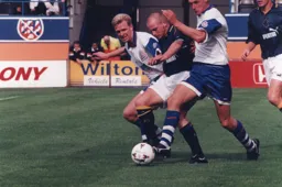 Lee Carsley is bundled off the ball by David Oldfield and John Taylor