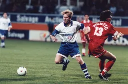 Gary Waddock wins this midfield battle