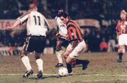Ceri Hughes about to skip past Ron Willems